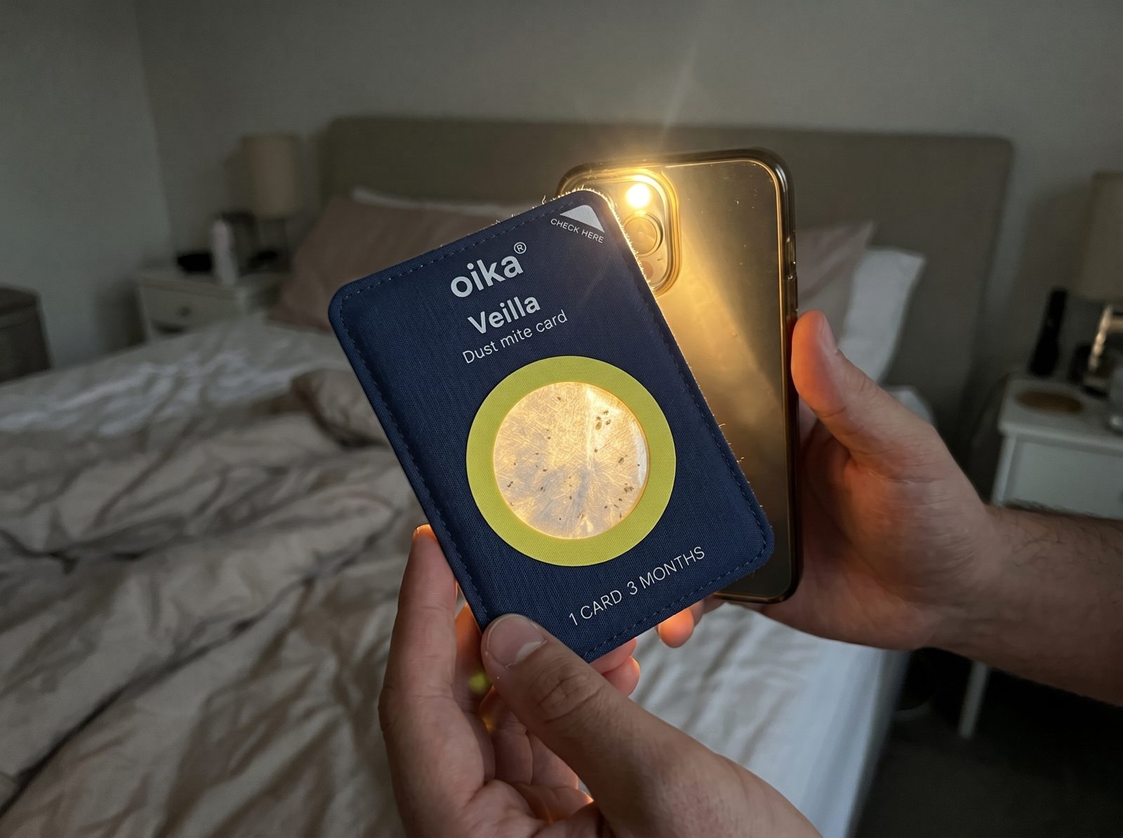 The used card held against a phone light