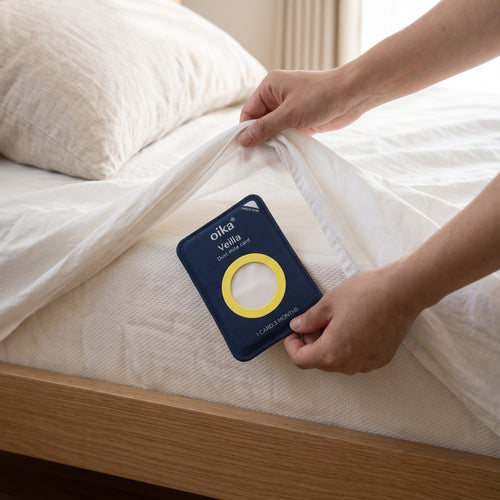 Slipping the Veilla card under the fitted sheet