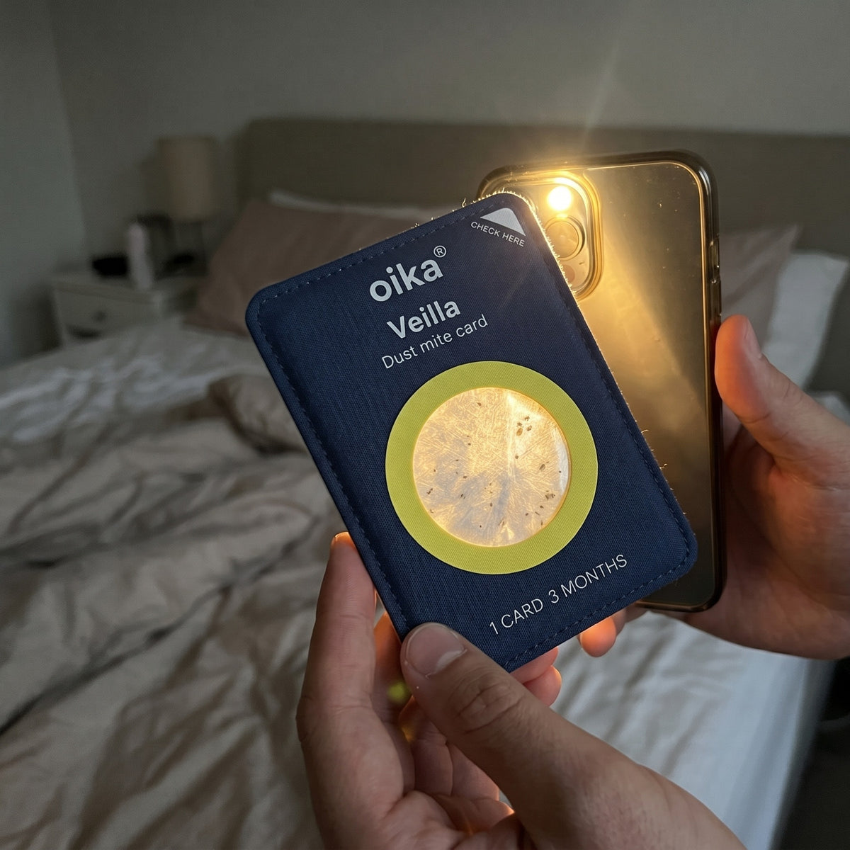 Checking a used Veilla card against a phone light